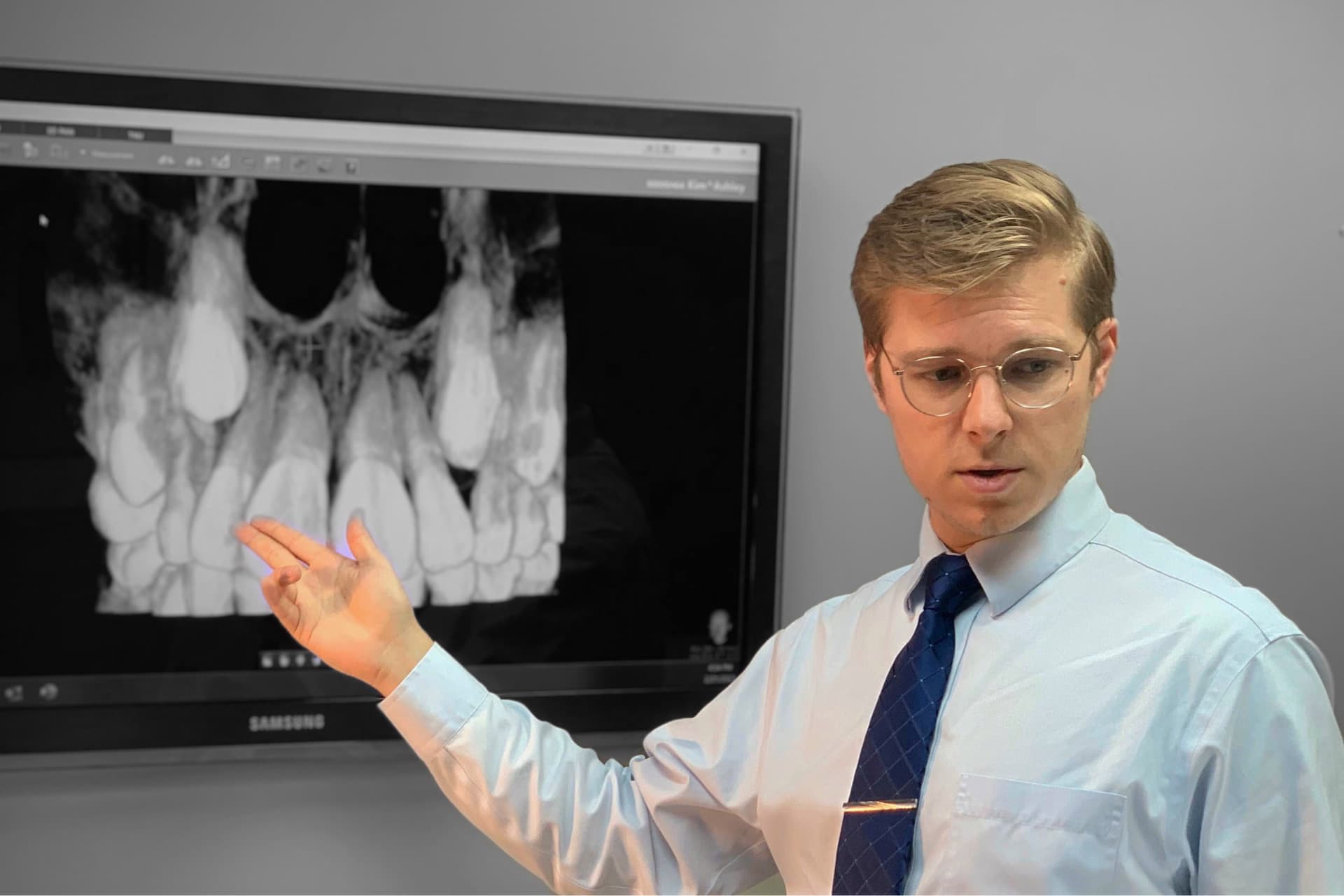 Dr Adam is pointing to an x-ray.